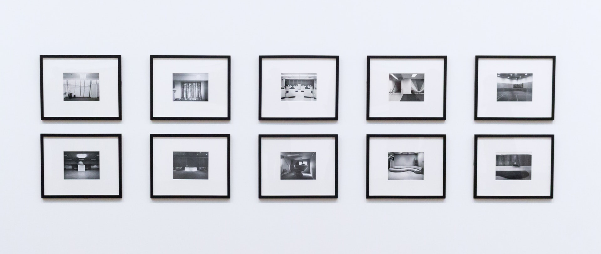 Wall of ten framed black and white photographs