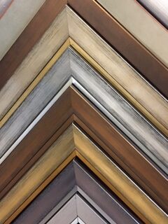 picture frames of various colors stacked on top of each other