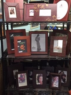 various pictures placed in frames on a shelf
